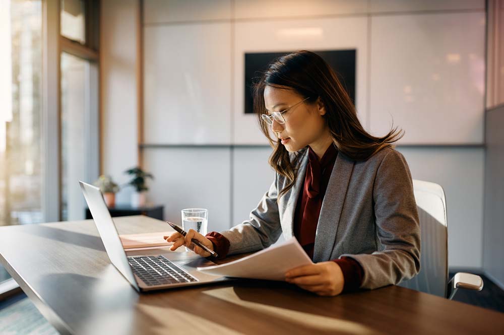 Woman checking files on laptop